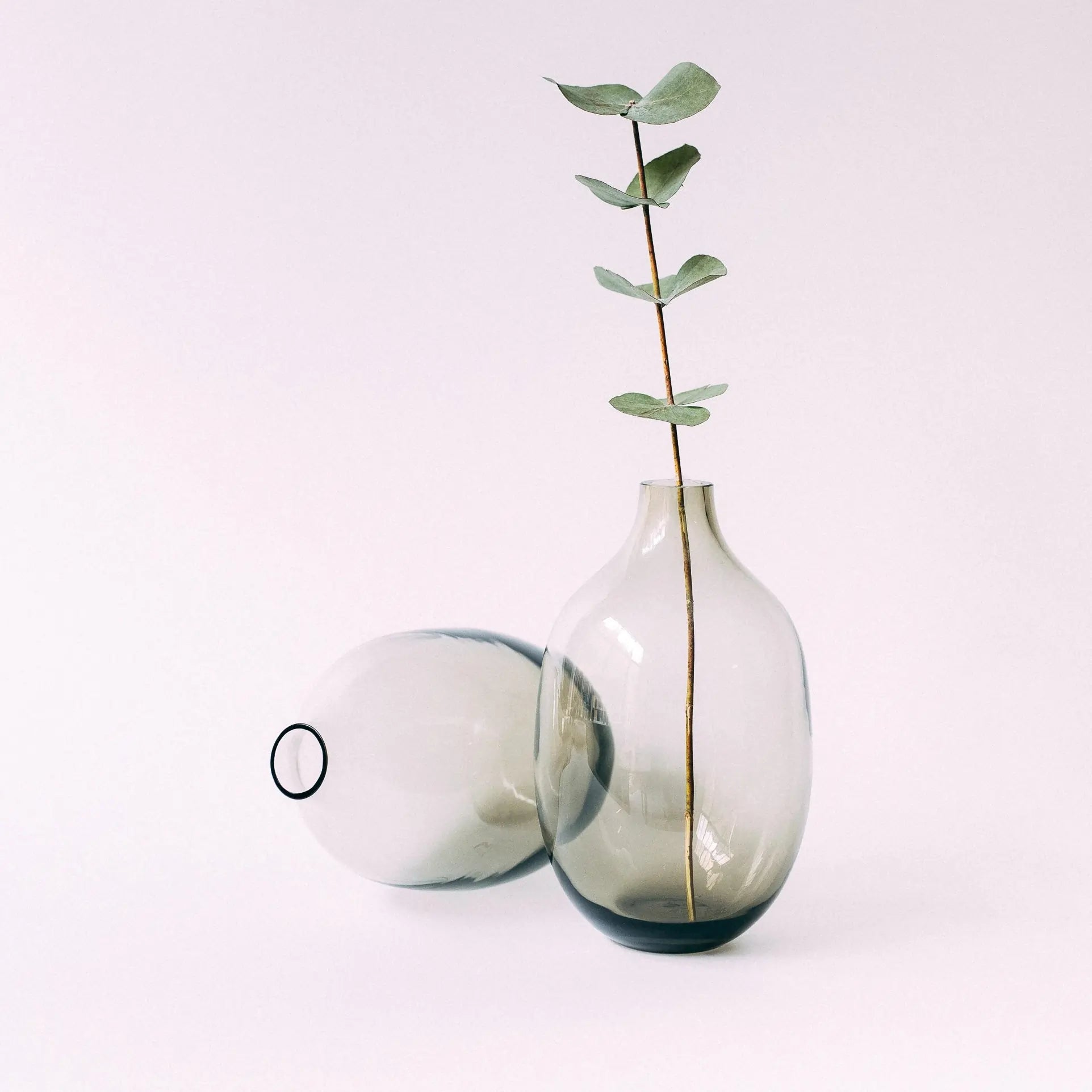 Dwa szklane wazony Ganna Glass w odcieniach zieleni i szarości - ułożone w artystyczny layout